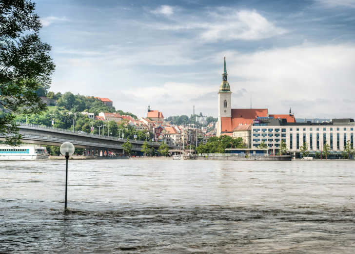 Langs de Donau de St. Martinuskathedraal en op de achtergrond het Slavín-Monument op de berg Bezienswaardigheden Stedentrip Bratislava: St. Martinuskathedraal & Slavín-Monument